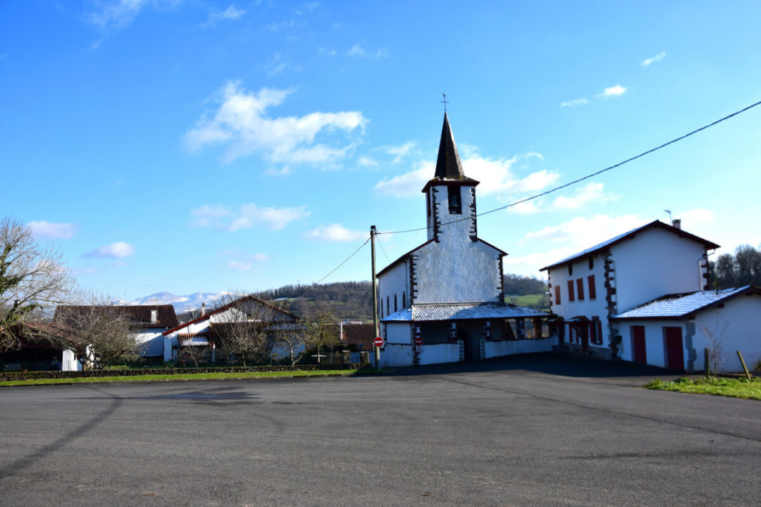 Church of Lasse with snowy Pyrenees mountains